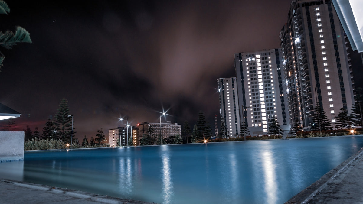 swimming pool near building at night