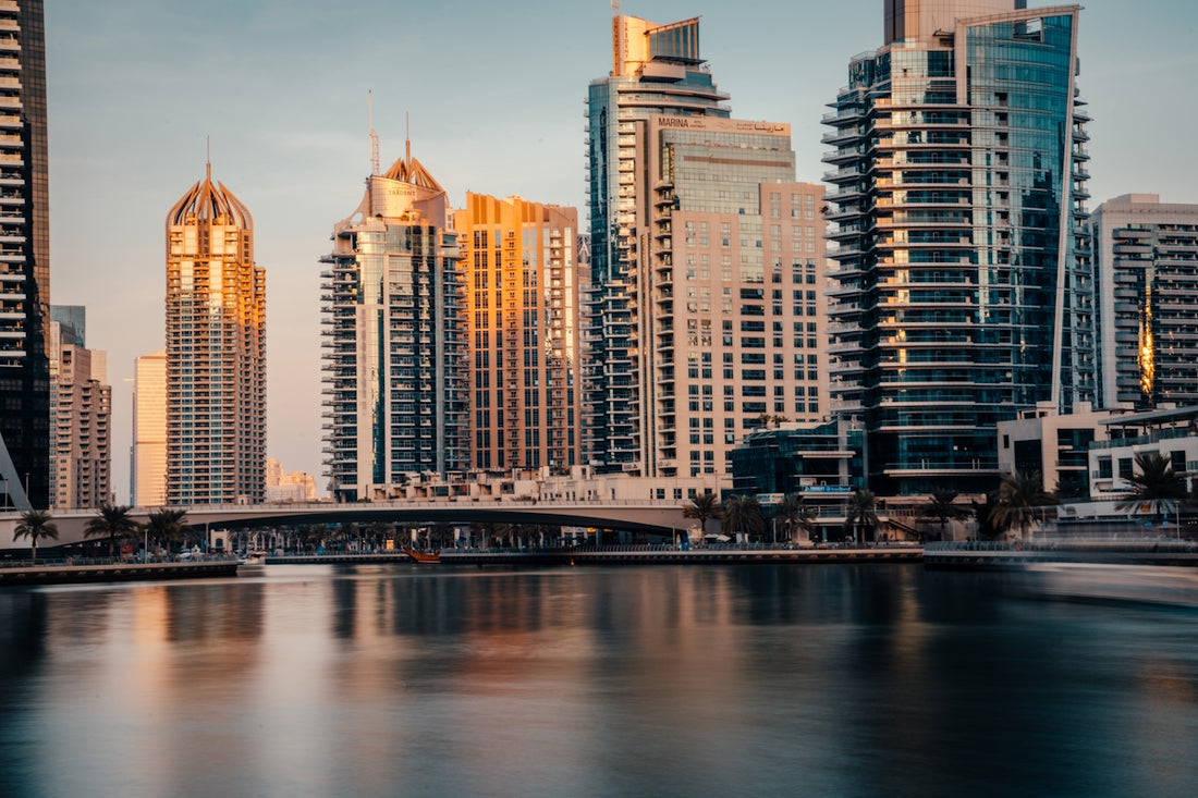 a city skyline with a bridge over a river