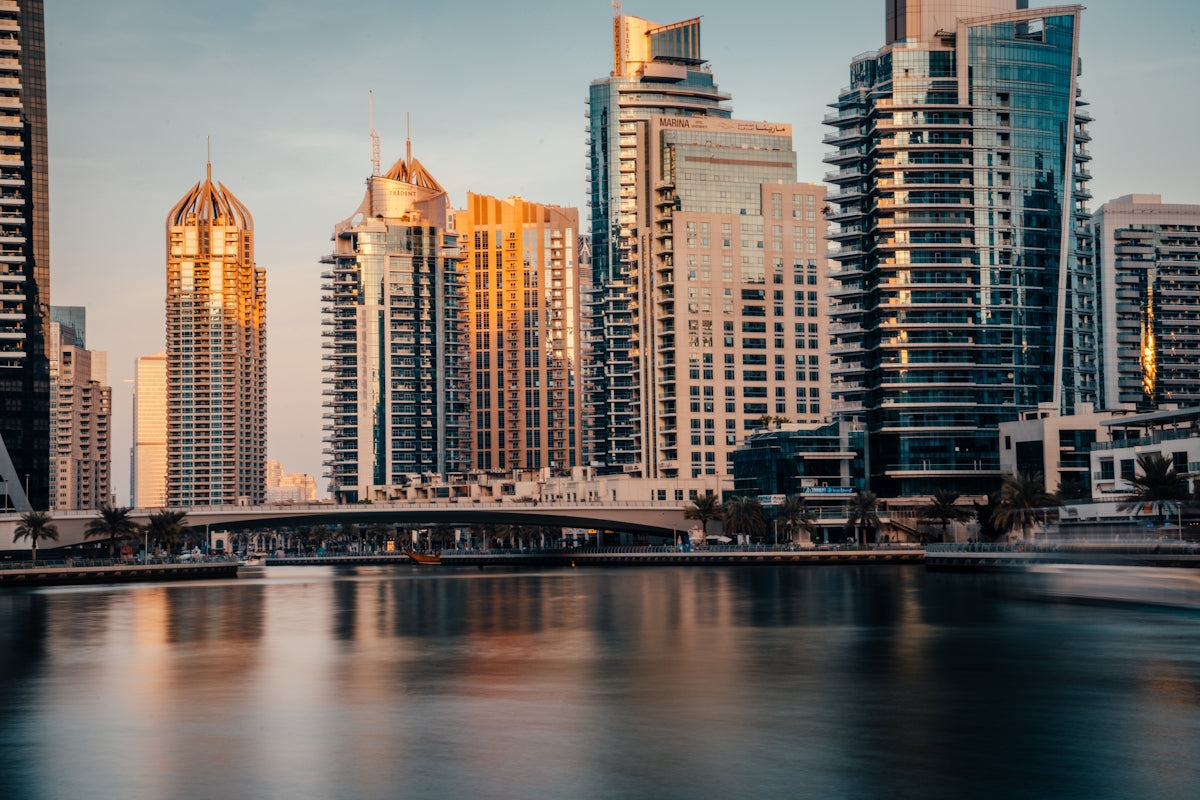 a city skyline with a bridge over a river