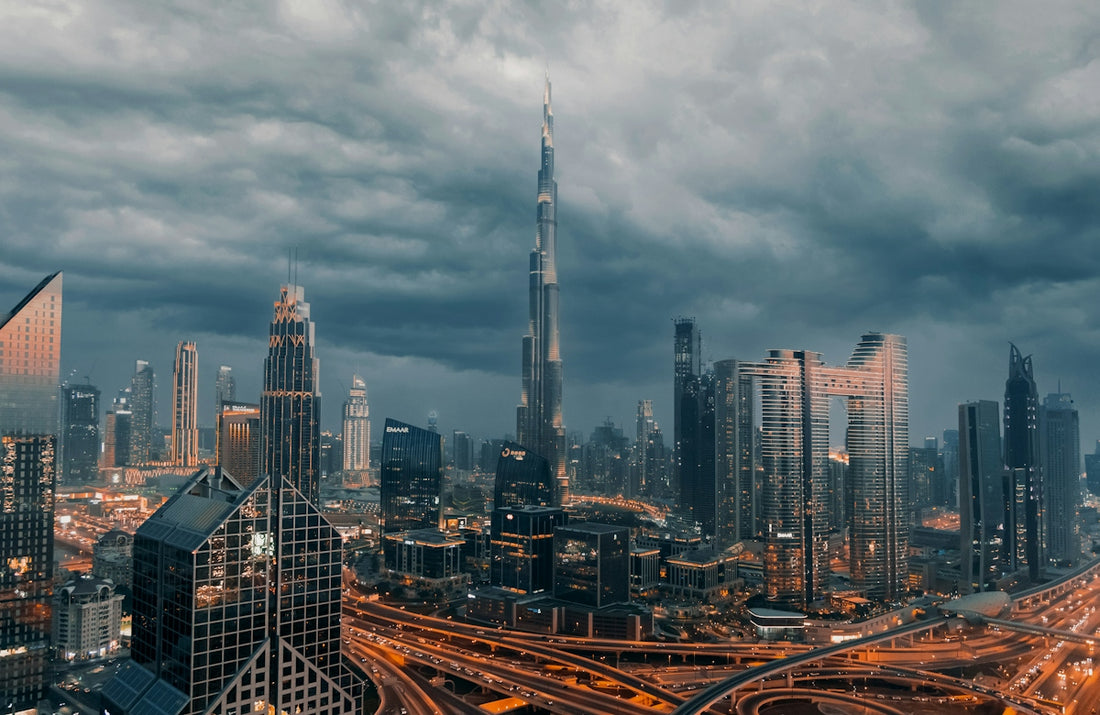 The Burj Khalifa rising above the skyline of Downtown Dubai under dark storm clouds