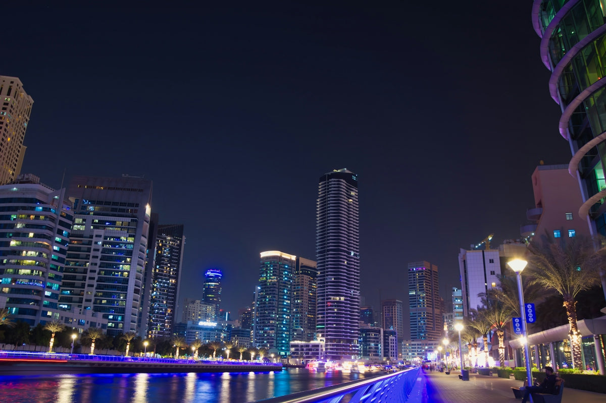 a city at night with lights reflecting in the water