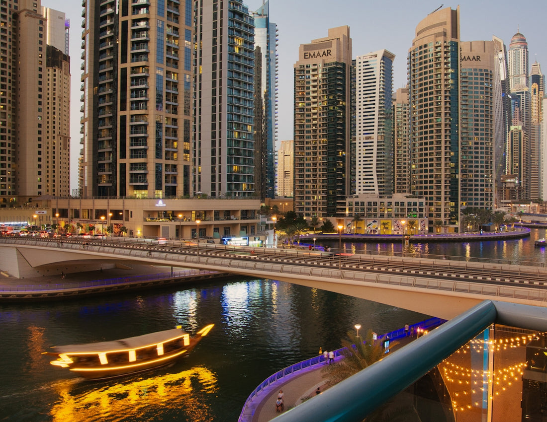a boat floating on top of a river next to tall buildings