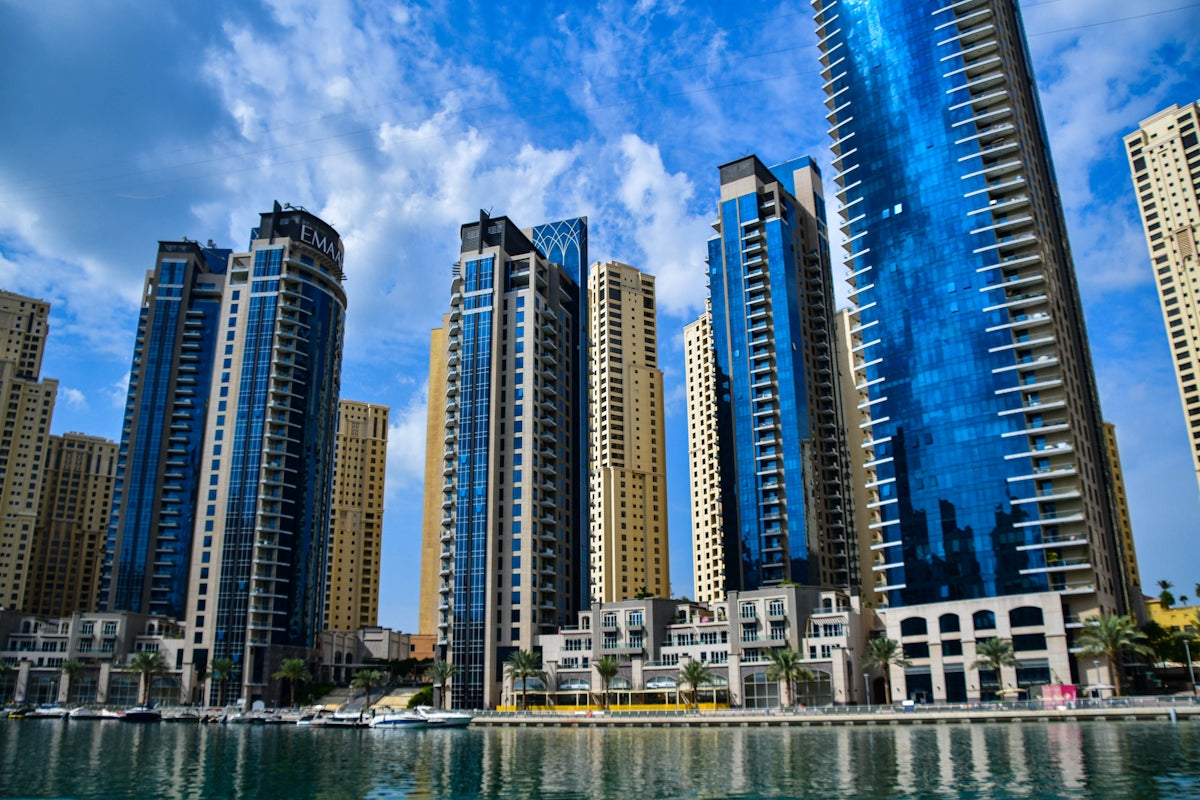 a group of tall buildings next to a body of water
