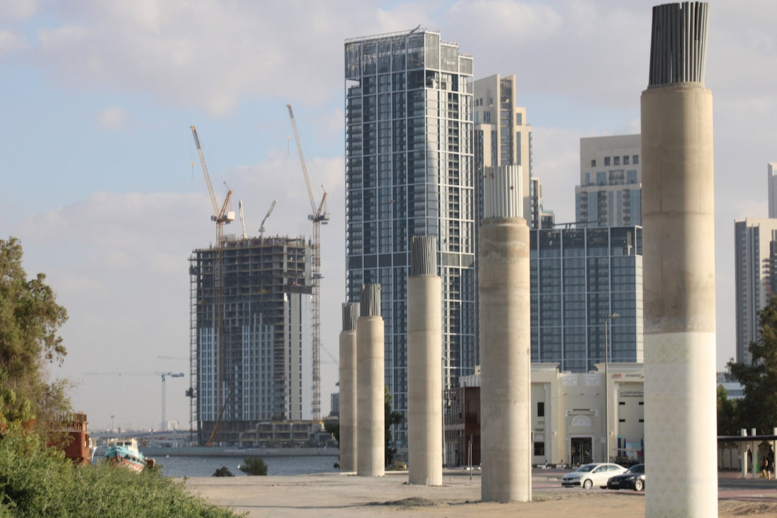 a group of tall buildings next to a body of water