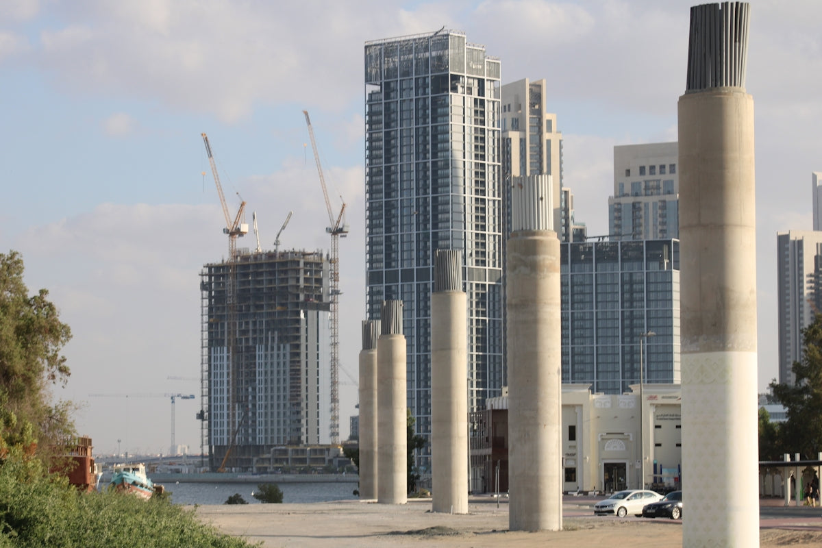 a group of tall buildings next to a body of water