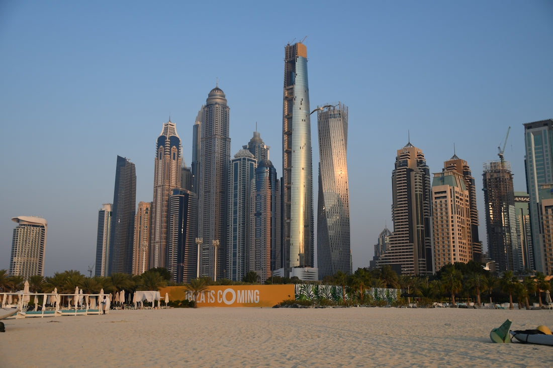 a beach with a lot of tall buildings in the background