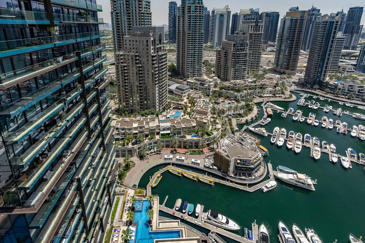 An aerial view of a city with boats in the water