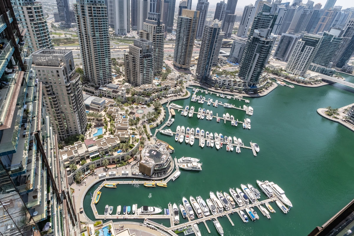 An aerial view of a city with boats in the water