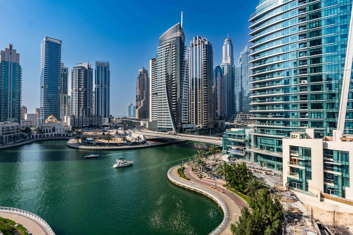 A river running through a city next to tall buildings