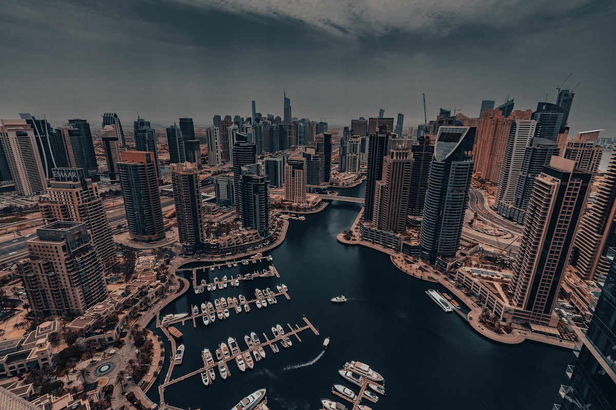 An aerial view of a city with boats in the water