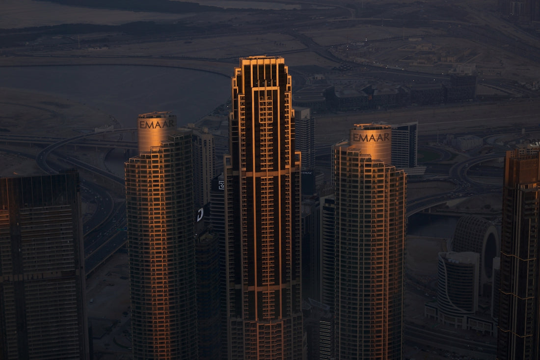 A view of a city at night from the top of a skyscraper