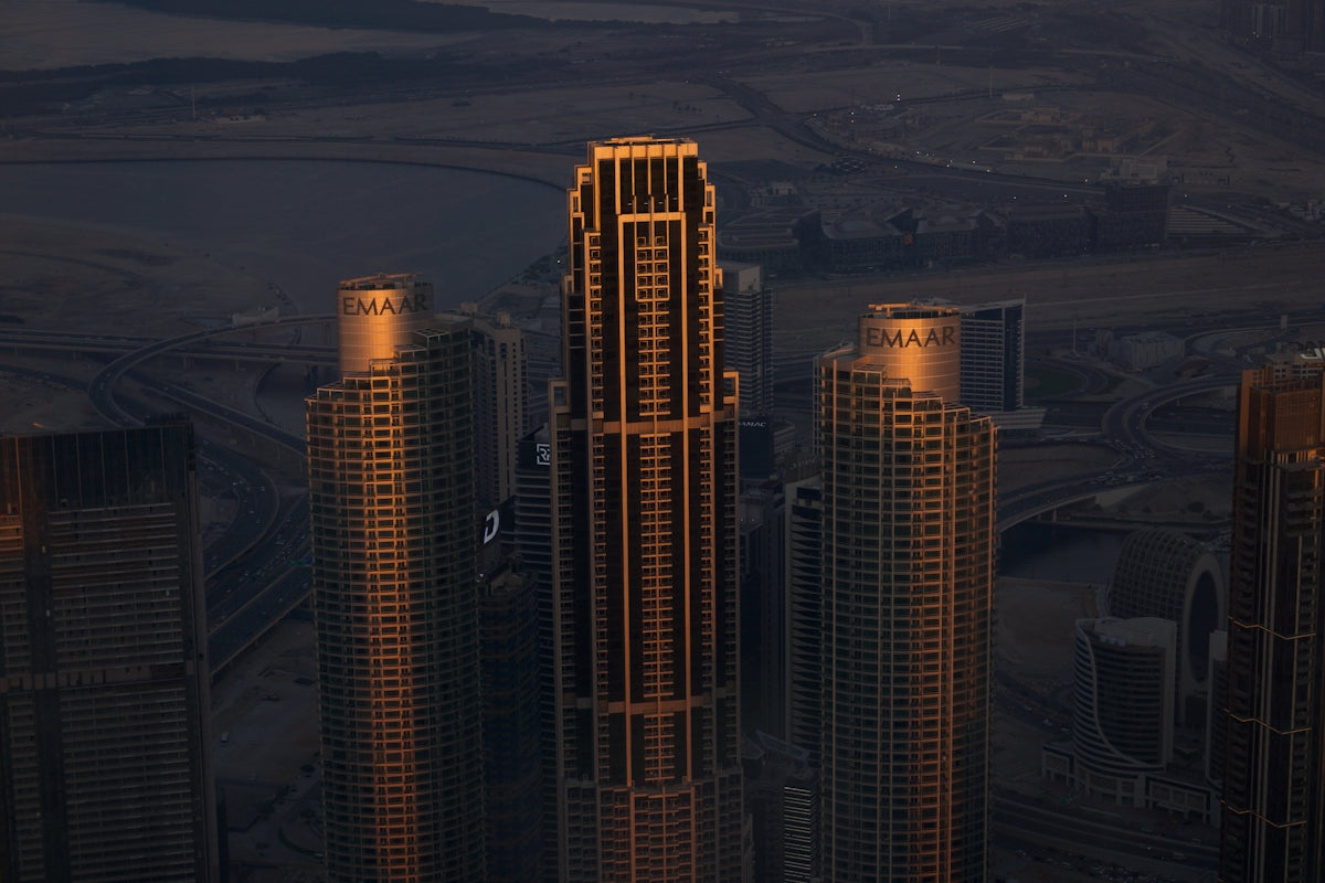 A view of a city at night from the top of a skyscraper