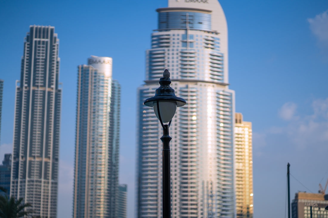 A street light in front of some tall buildings