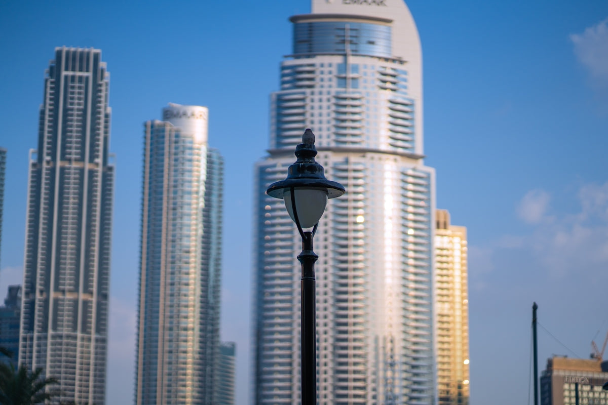 A street light in front of some tall buildings