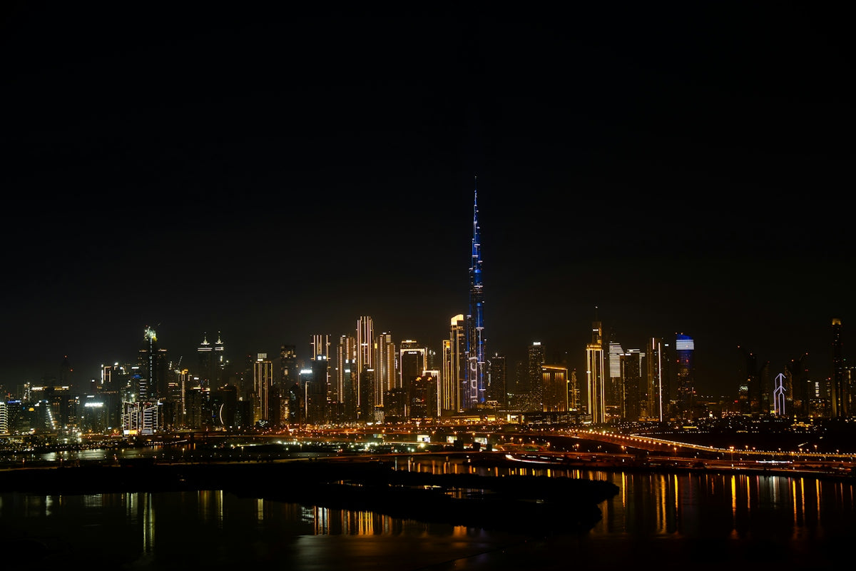 Dubai city skyline illuminated at night with burj khalifa